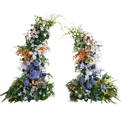 This is a colorful artificial floral arch. It features a rich palette including purple, orange, pink, white, and yellow. There are various flower styles like hydrangeas, roses, and smaller blooms. The overall style is vibrant and full of natural charm. 