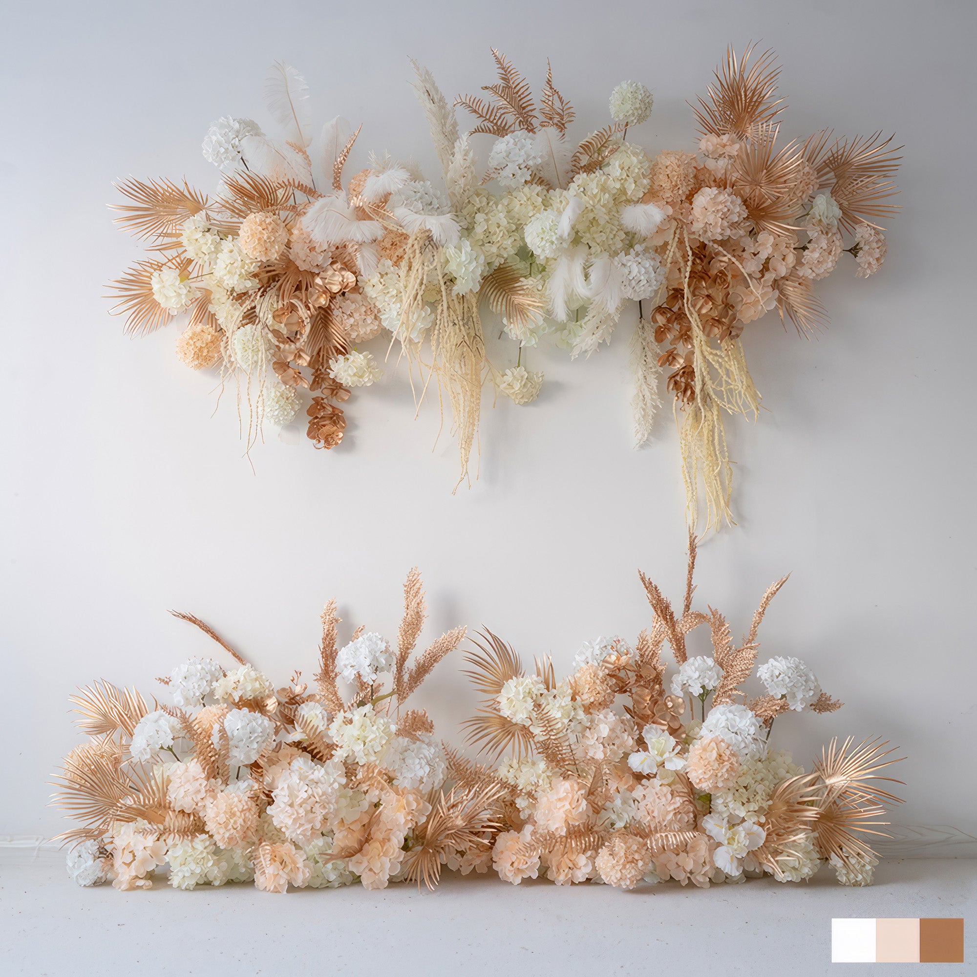 This image features artificial flower arrangements in soft white, peach, and hints of gold - toned foliage. There are hydrangea - like blooms and palm - like fronds. The style is elegant and modern, perfect for event decor. 