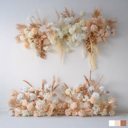 This image features artificial flower arrangements in soft white, peach, and hints of gold - toned foliage. There are hydrangea - like blooms and palm - like fronds. The style is elegant and modern, perfect for event decor. 