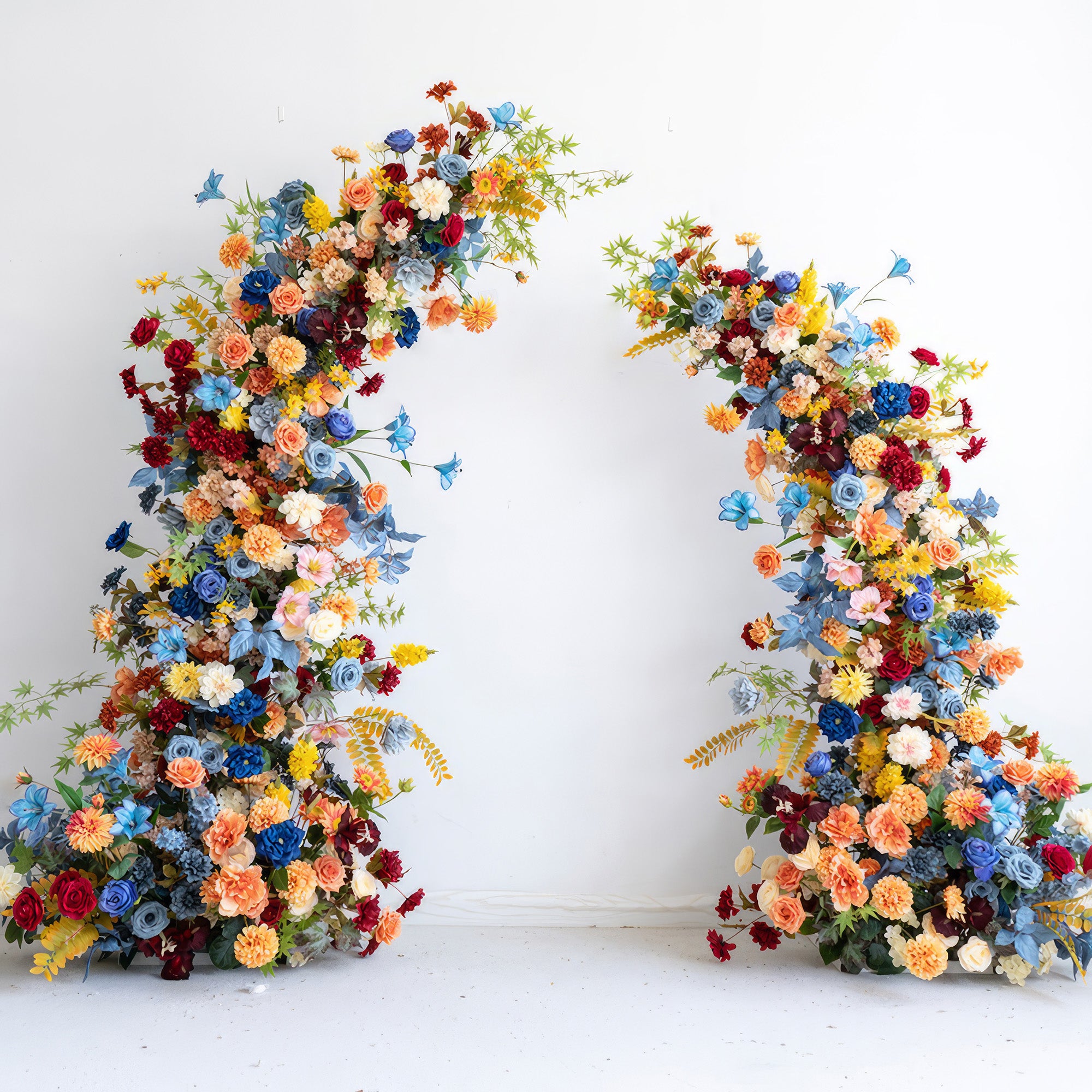This image showcases a vibrant artificial floral arch. The color palette is rich and diverse, including shades of blue, orange, yellow, red, and various pastel tones. It features a mix of different - sized flowers like roses and daisy - like blooms. The overall style is lively and eye - catching, perfect for a festive or celebratory event. 