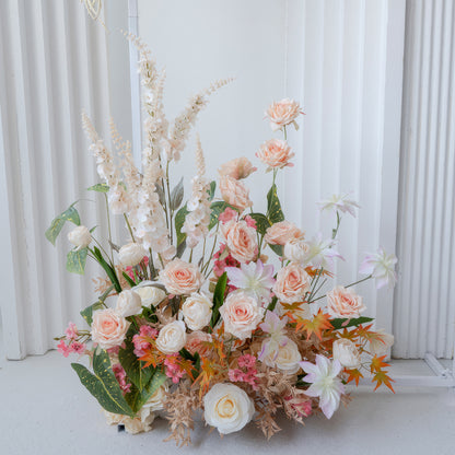 This image features an artificial flower arrangement with roses as the main type, along with other blooms. Colors include soft peach, white, and touches of pink and orange. The style is elegant and natural - looking. 