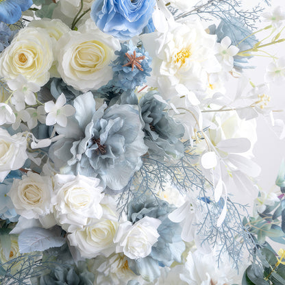 This image showcases a cluster of artificial flowers in a serene blue - and - white color scheme. White roses and various white blooms are paired with blue flowers in different shades, like blue roses and large blue - gray blossoms, along with blue - toned foliage. The arrangement exudes an elegant, tranquil, and layered style, perfect for decorating weddings, sophisticated parties, and similar events. 
