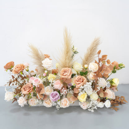 This is a charming artificial flower arrangement. It features roses in soft pastel colors such as peach, pink, lavender, and cream. Accented with pampas grass and brownish - orange leaves, along with small white filler flowers, it has a warm, natural, and romantic style. 