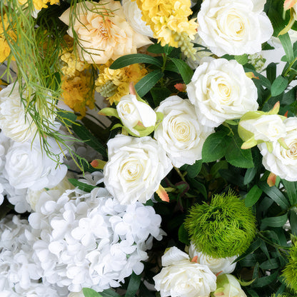 This close - up showcases an artificial flower arrangement with a color scheme of white, yellow, and green. It includes white roses and hydrangeas, yellow blossoms, and green spherical foliage, presenting a fresh and elegant style. 