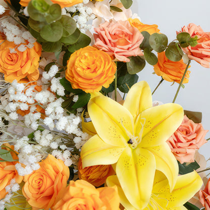 This is a vibrant flower arrangement. It includes bright yellow lilies as the focal point, surrounded by orange and peach - colored roses. White baby&