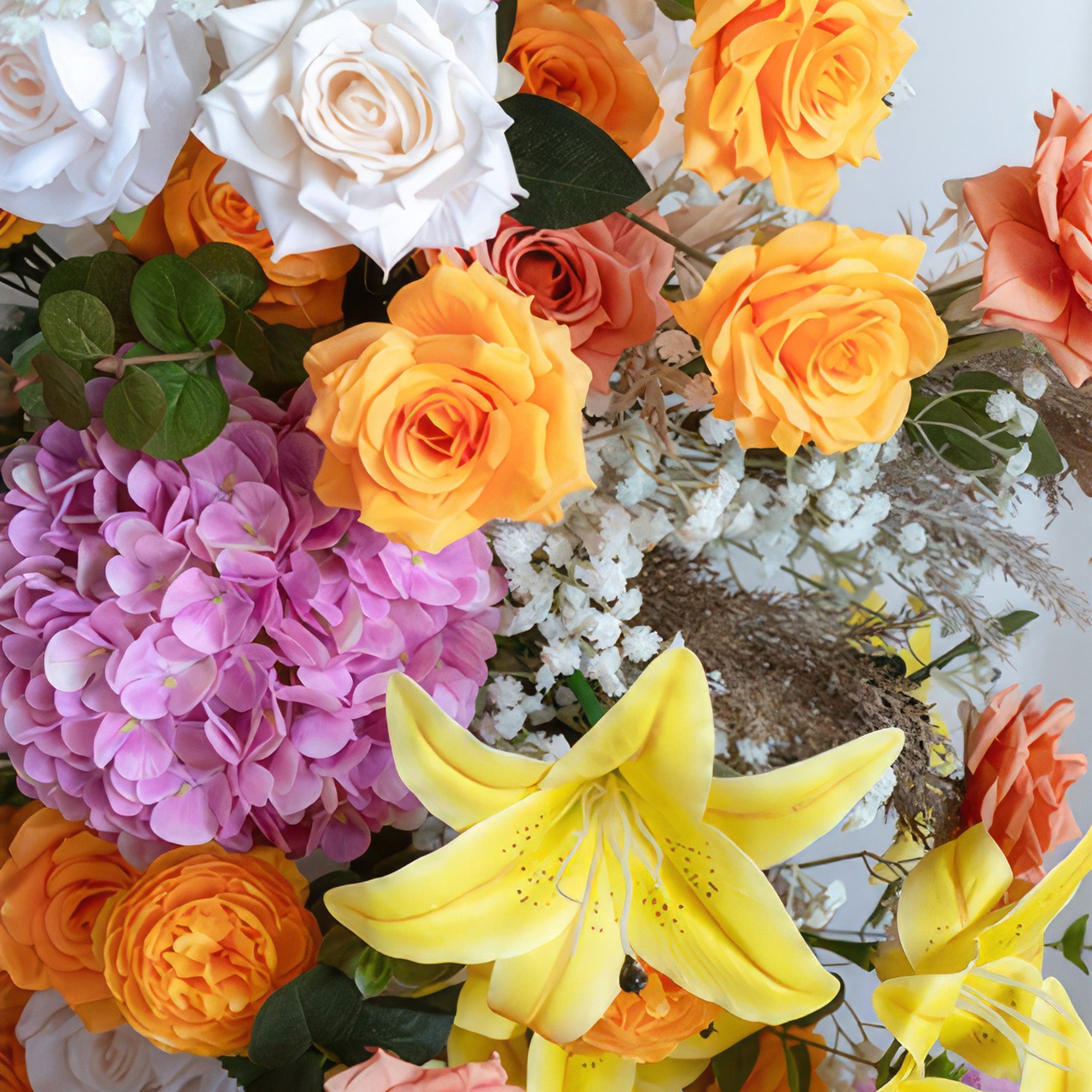 This is a vivid and eye - catching flower arrangement. It combines bright yellow lilies, orange and peach - toned roses, large purple hydrangeas, and white roses. There are also white baby&