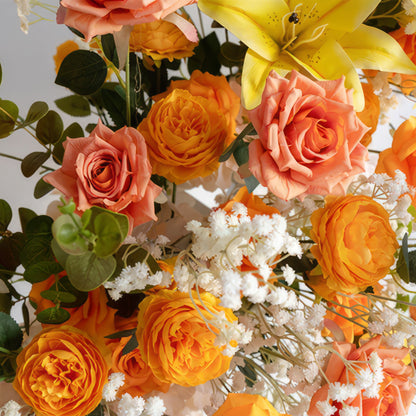 This is a charming flower arrangement with a warm color scheme. It features a mix of orange and peach - hued roses, which are the main elements. Among them, there are also small clusters of white baby&