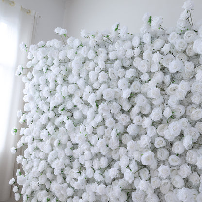This image showcases a dense arrangement of white artificial roses, forming a lush and voluminous floral display. The flowers are tightly packed, with their soft, creamy petals and subtle green stems creating a sense of purity and elegance. Set indoors, likely near a window with light filtering through, the scene exudes a serene and sophisticated atmosphere. It&