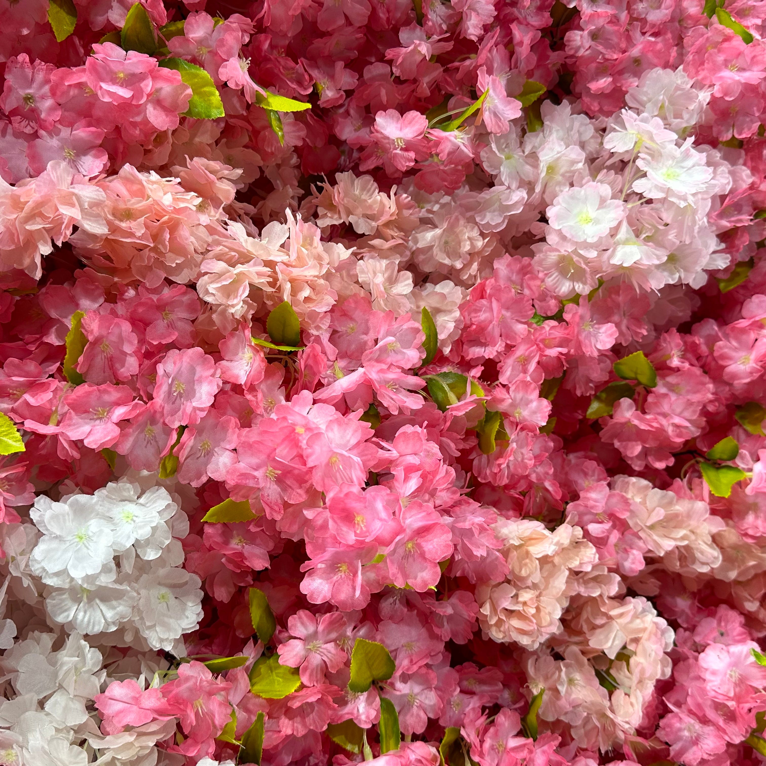 Valar Flowers premium artificial cherry blossom flower wall panel, a dense, lush floral backdrop in gradient pink and white blooms with vibrant green leaves. Perfect for weddings, spring events, bridal showers, photo booths, and party decor, this lifelike cherry blossom wall delivers a dreamy, romantic, ethereal aesthetic.