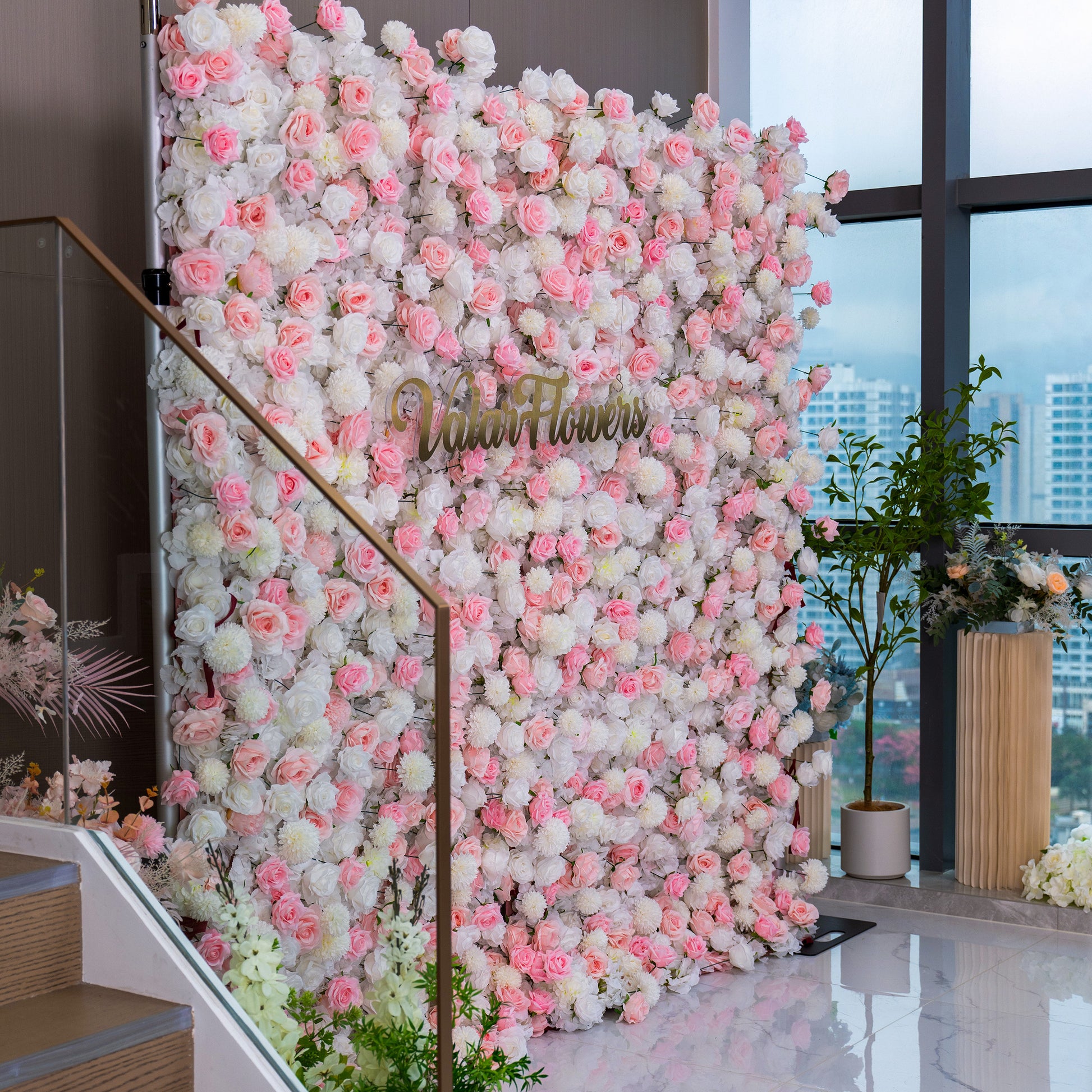 The image features a beautiful floral wall adorned with pink and white flowers. Prominently displayed in the center is the text "Valar Flowers," suggesting it's a decorative backdrop, ideal for weddings or events.