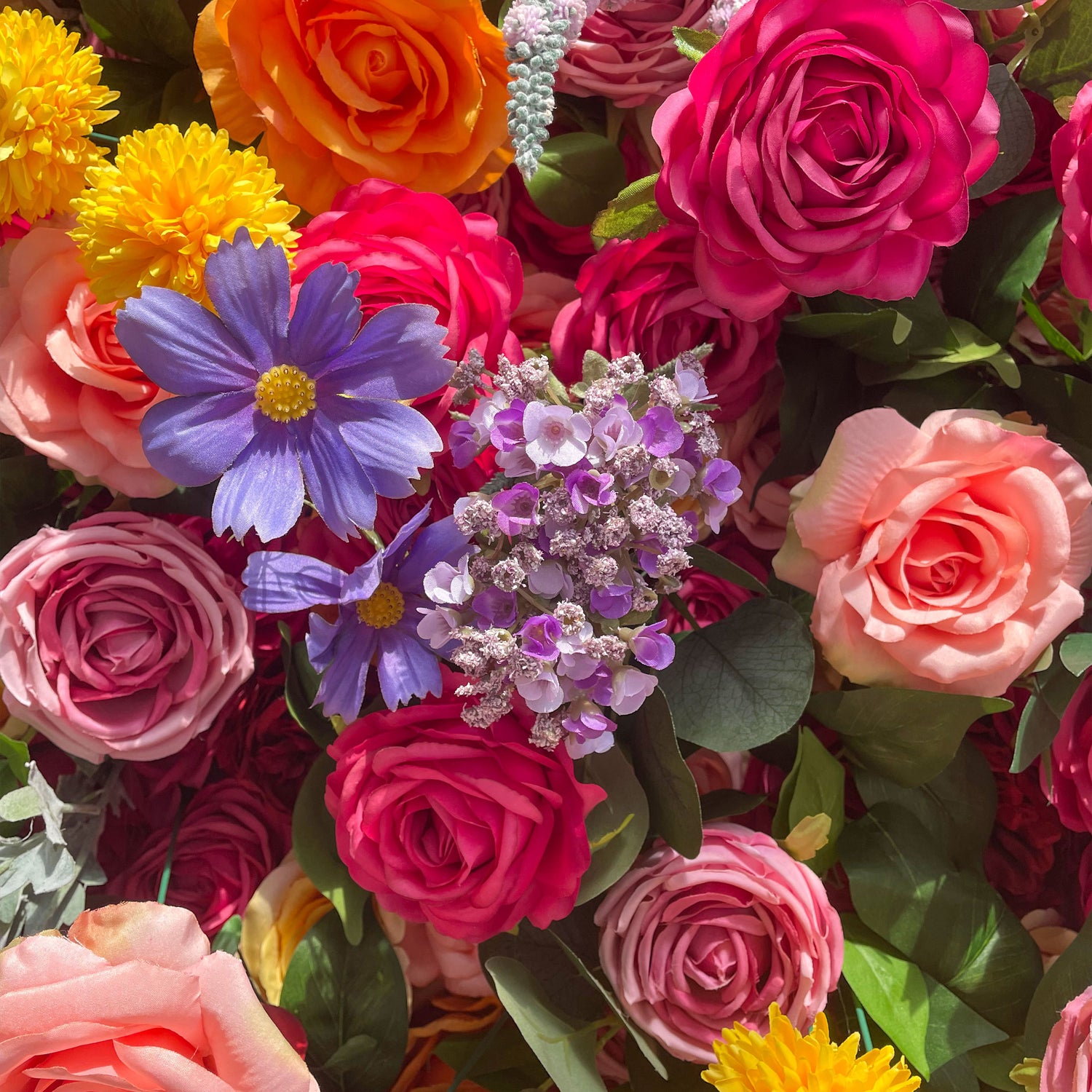 This artificial flower wall is a vibrant and eye - catching decoration. It features a rich variety of colorful flowers, including roses, daisies, and other blooms in shades of pink, orange, yellow, purple, and blue. The flowers are densely arranged with green leaves, creating a lush and lively appearance. It is perfect for adding a festive and romantic atmosphere to events.