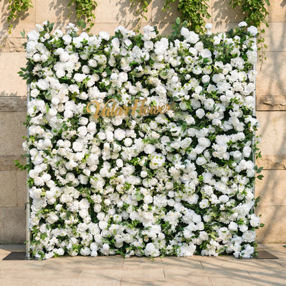 This stunning artificial flower wall backdrop by Valar Flowers features a lush, all-white design with soft roses, peonies, delicate baby’s breath, and trailing greenery, centered with a metallic "ValarFlowers" logo. Crafted with hyper-realistic, maintenance-free blooms, this reusable display creates an elegant, timeless focal point, ideal for weddings, photo booths, luxury events, and studio decor, offering a clean, romantic aesthetic perfect for professional styling.