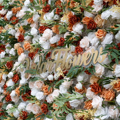 This is a lush, premium artificial flower wall from ValarFlowers, brimming with lifelike blooms in a warm terracotta and cream palette. It features burnt orange roses, creamy white peonies, blush pink roses, and vibrant green foliage, with the brand’s elegant gold script logo at the center. This dense, realistic, reusable arrangement creates a timeless, romantic focal point, perfect for rustic weddings, fall events, photo booths, and luxury event decor.