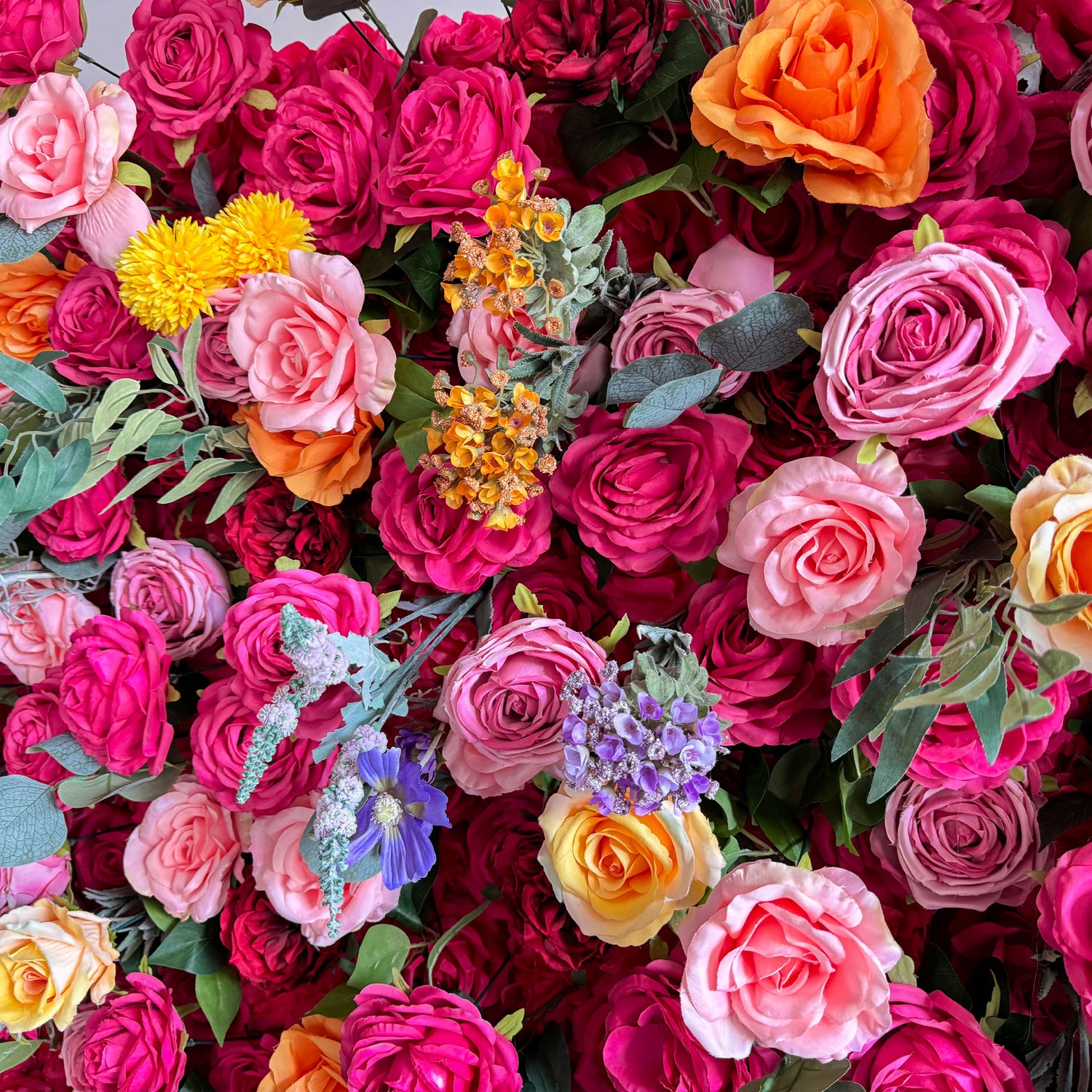 This artificial flower wall is a vibrant and luxurious decoration. It features a rich variety of colorful flowers, including roses in different hues. The flowers are densely arranged with green leaves, creating a lush and three - dimensional appearance. It is perfect for adding a romantic and festive atmosphere to events.