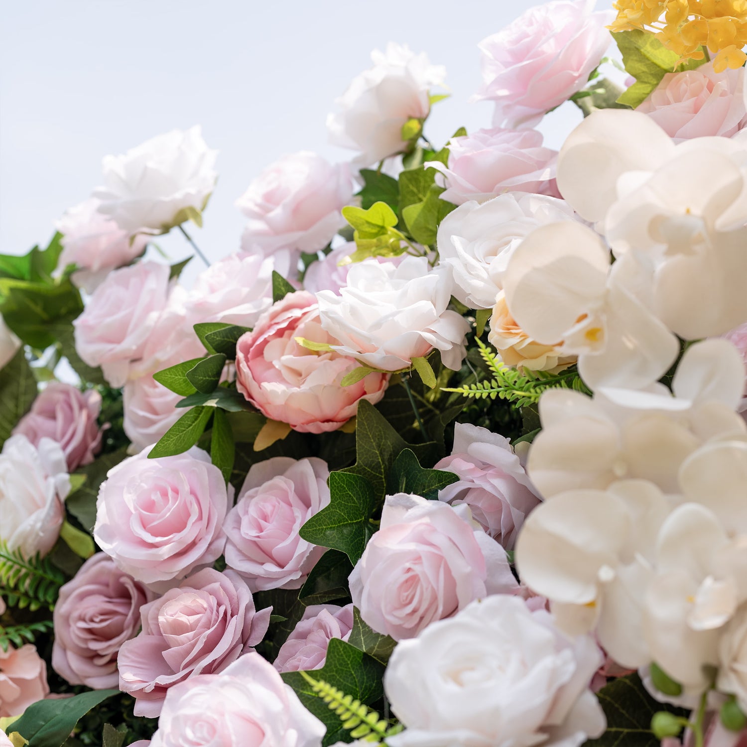 This is a lush, premium artificial flower arrangement, brimming with lifelike blooms in a dreamy soft pink and white palette. It features blush pink roses, creamy white roses, elegant white phalaenopsis orchids, pink peonies, and vibrant green foliage. The dense, realistic design creates a fresh, romantic, elegant focal point, perfect for wedding backdrops, photo booths, bridal showers, baby showers, and luxury event decor.