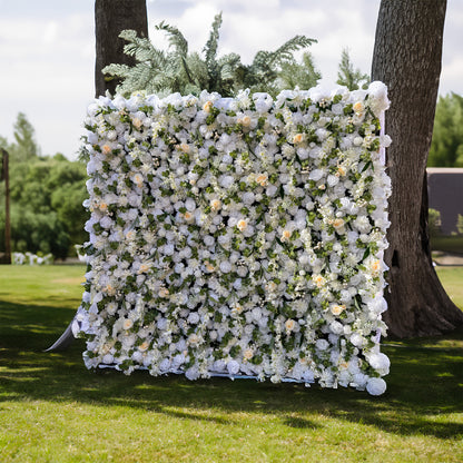 This wedding flower wall is a stunning decoration. It features a dense arrangement of white flowers with some soft - colored blooms interspersed, creating a harmonious and elegant look. The flowers are complemented by lush green foliage. Set against a natural outdoor backdrop, it provides a romantic and picturesque setting for weddings.