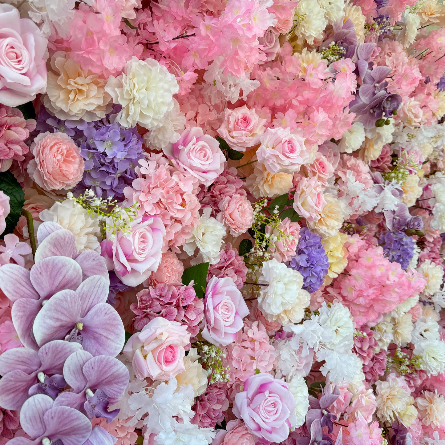 This photo from ValarFlowers presents a lush floral arrangement. It features an assortment of roses in soft pink hues, alongside hydrangeas in shades of purple and pink. White carnations and delicate white flowers add to the mix, with pink cherry - blossom - like flowers enhancing the dreamy feel. Purple orchids provide a touch of elegance. Ideal for weddings, bridal showers, or romantic events, it exudes charm and grace. 