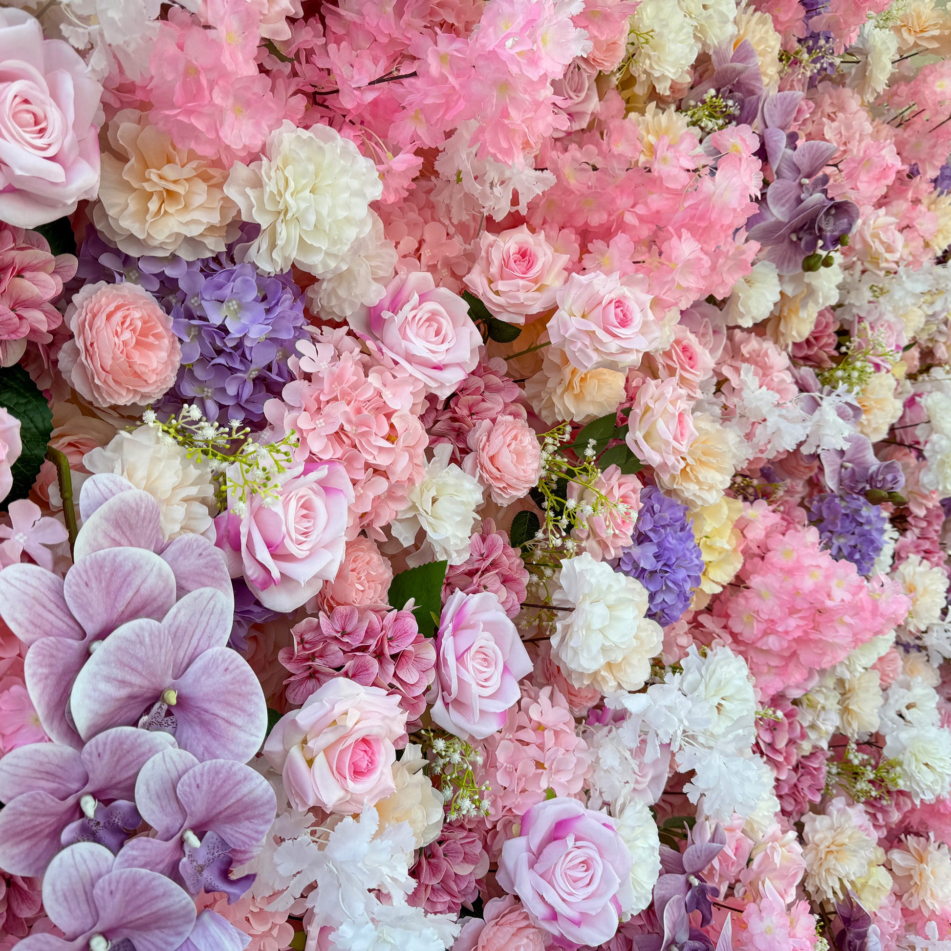 This photo from ValarFlowers presents a lush floral arrangement. It features an assortment of roses in soft pink hues, alongside hydrangeas in shades of purple and pink. White carnations and delicate white flowers add to the mix, with pink cherry - blossom - like flowers enhancing the dreamy feel. Purple orchids provide a touch of elegance. Ideal for weddings, bridal showers, or romantic events, it exudes charm and grace. 