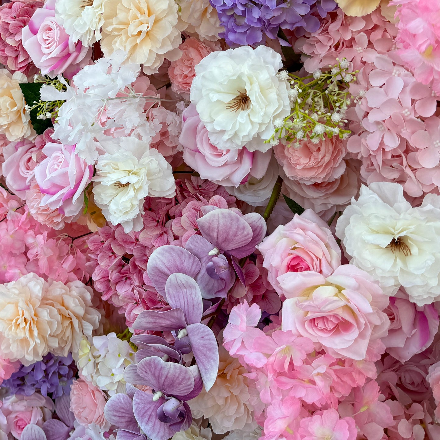 This photo from ValarFlowers showcases a lush floral arrangement. It features roses in soft pink and white tones, hydrangeas in purple and pink, along with delicate white flowers and small green - stemmed blooms. Large purple orchids add an elegant touch. Ideal for weddings, bridal showers, or romantic events, this dreamy and colorful mix exudes charm and sophistication. 