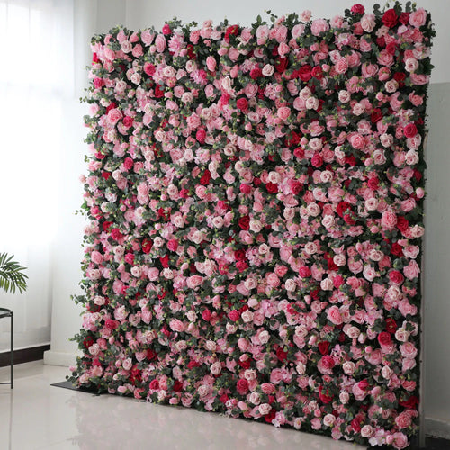 Valar Flowers' Artificial Fabric Flower Wall: Blooming Bliss. A large artificial flower wall bursts with a vibrant mix of pink, light pink, and red roses, interspersed with green foliage. The dense, layered blooms create a lush, romantic, and eye - catching backdrop, perfect for adding a touch of elegance and charm to events or spaces. 