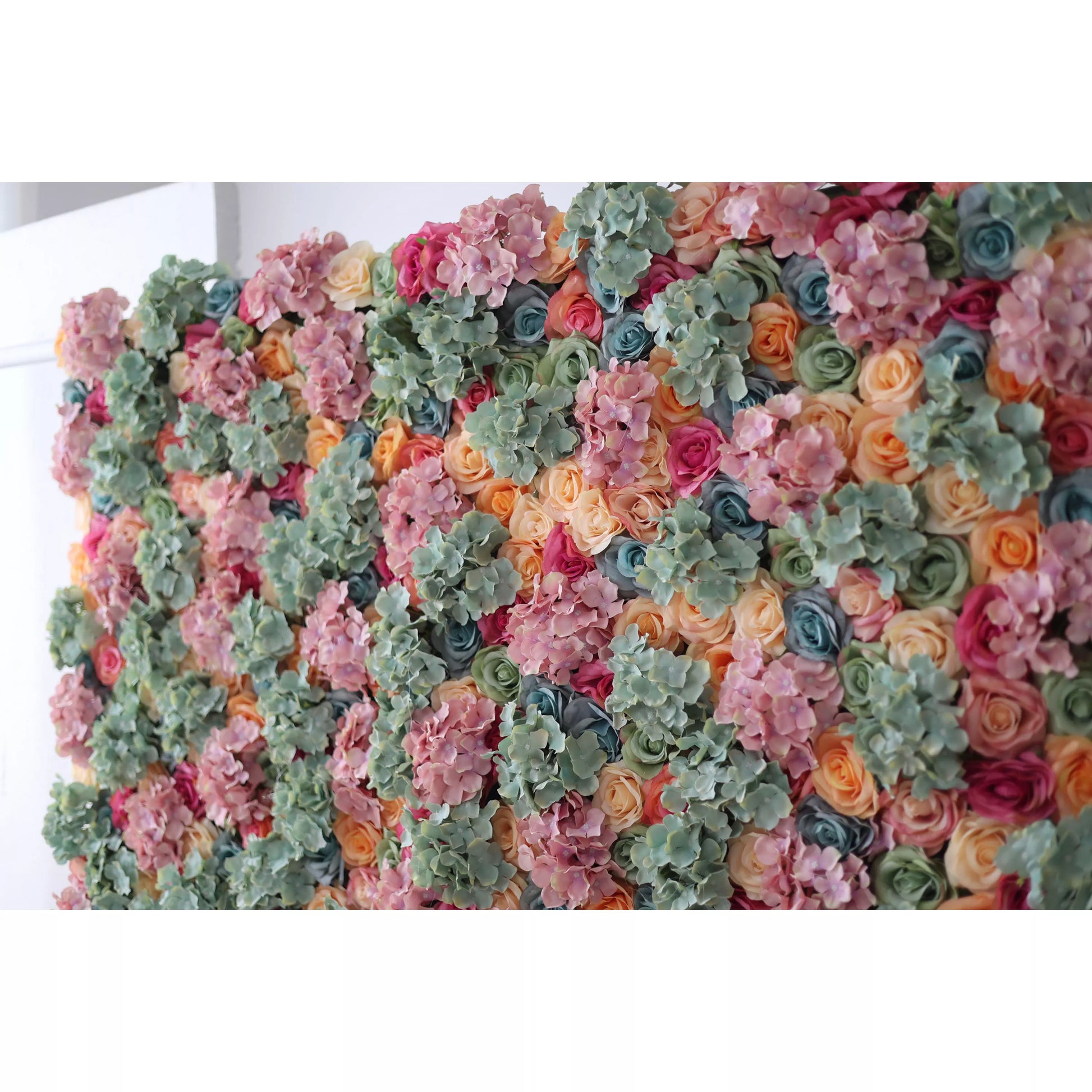 This large artificial flower wall is a vibrant tapestry of colors. It features soft pink hydrangeas, mint - green foliage, and a mix of peach, coral, and red roses, along with blue blooms. The dense, varied arrangement creates a lush, textured display, evoking a sense of natural beauty and charm. Perfect as a backdrop for events like weddings or parties, it adds an elegant, colorful touch to any space, enhancing the decorative appeal with its intricate floral design. 