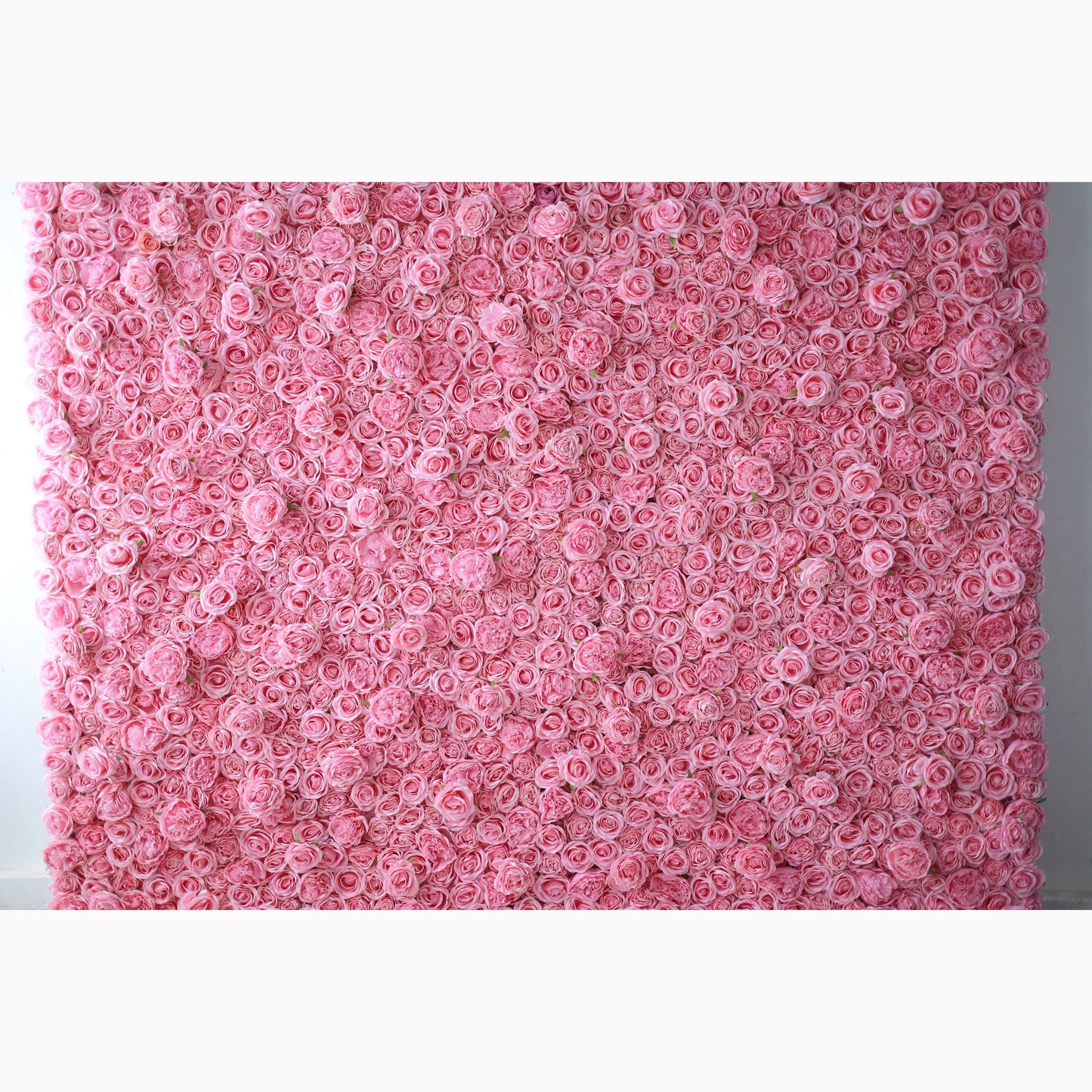 A vast artificial flower wall features a dense arrangement of uniform pink roses. Each bloom is tightly clustered, creating a smooth, lush, and romantic texture. The consistent soft - pink hue exudes a gentle, elegant, and dreamy vibe, perfect for adding a sweet, charming touch to decor or event backdrops. 