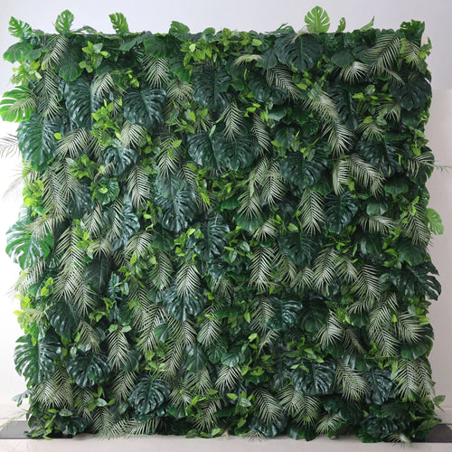 Valar Flowers' Artificial Fabric Green Wall: Tropical Eden. A luxuriant cascade of varied green leaves, meticulously crafted, capturing the heart of a tropical jungle, and radiating verdant serenity. A large artificial greenery wall features a dense mix of lush leaves. Big monstera leaves and delicate fern - like fronds in various shades of green create a vibrant, tropical - inspired texture. It’s a fresh, natural - looking backdrop, perfect for adding an organic touch to decor or events. 