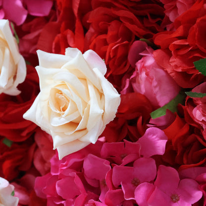 This close-up from **Valar Flowers** features a lush, textured arrangement of blooms: a prominent creamy white rose at the center, surrounded by vibrant red hydrangeas and soft pink hydrangeas. The dense, layered design creates a rich, three-dimensional texture, evoking a bold, romantic, and naturally elegant atmosphere ideal for weddings, photo backdrops, or elegant celebrations.