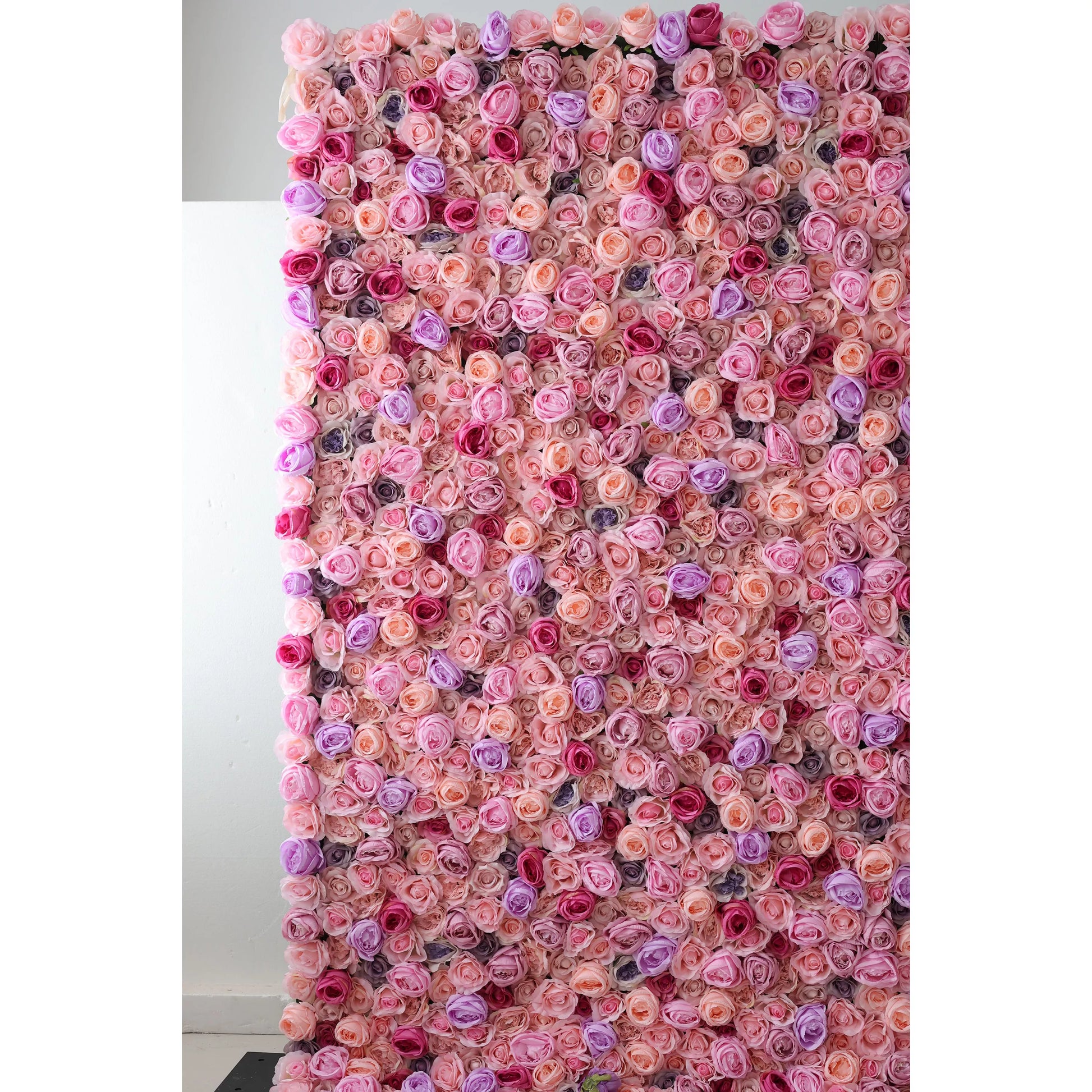 This large artificial flower wall features a dense, vibrant mix of pink, peach, purple, and red roses. The harmonious arrangement creates a lush, romantic texture, exuding elegance. Ideal as an event backdrop, it brings a dreamy, charming atmosphere with its intricate, colorful floral design. 