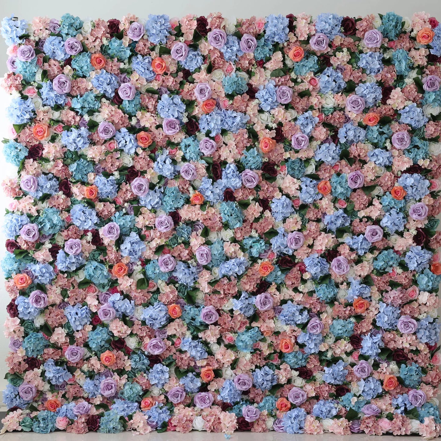 This large artificial flower wall features a lush mix of blue hydrangeas, purple roses, peach - toned blooms, and greenery. Densely packed, the varied colors and textures create a vibrant, romantic display, perfect for event backdrops, adding an eye - catching, elegant charm to any space. 