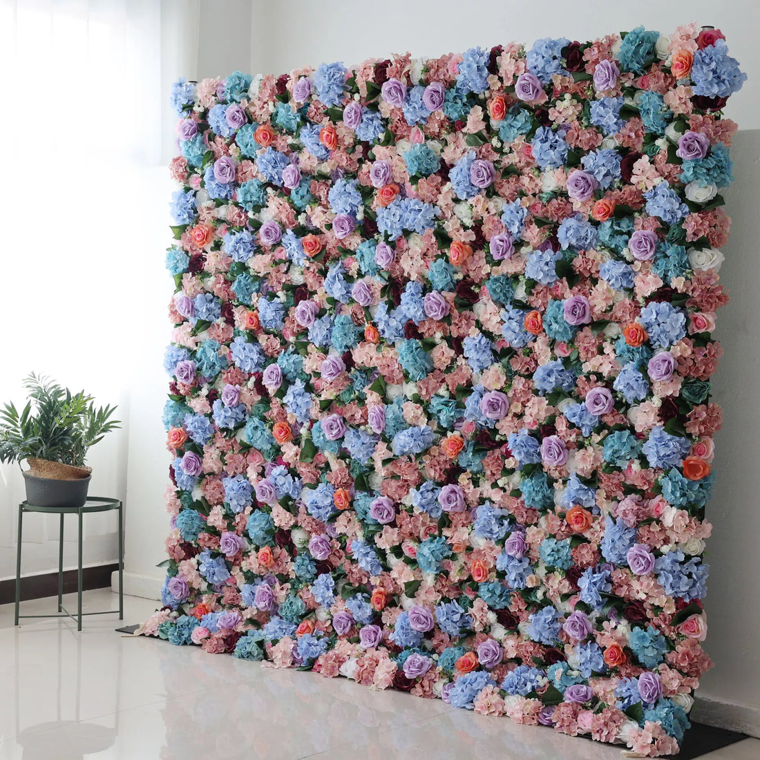 This large artificial flower wall bursts with colors—blue hydrangeas, purple roses, peach blooms, and greenery. Densely packed, it creates a lush, vibrant display. Perfect for events, it brings a cheerful, romantic vibe, adding an eye - catching, decorative charm to the space.