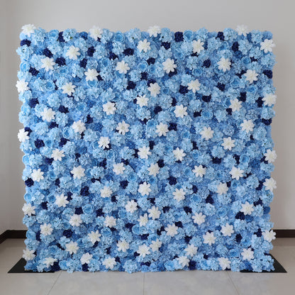A large artificial flower wall features a stunning arrangement of blue hydrangeas, white blooms, and dark blue blossoms. The dense, uniform pattern creates a serene, elegant backdrop, perfect for events or decorative displays, evoking a calm and sophisticated ambiance. 