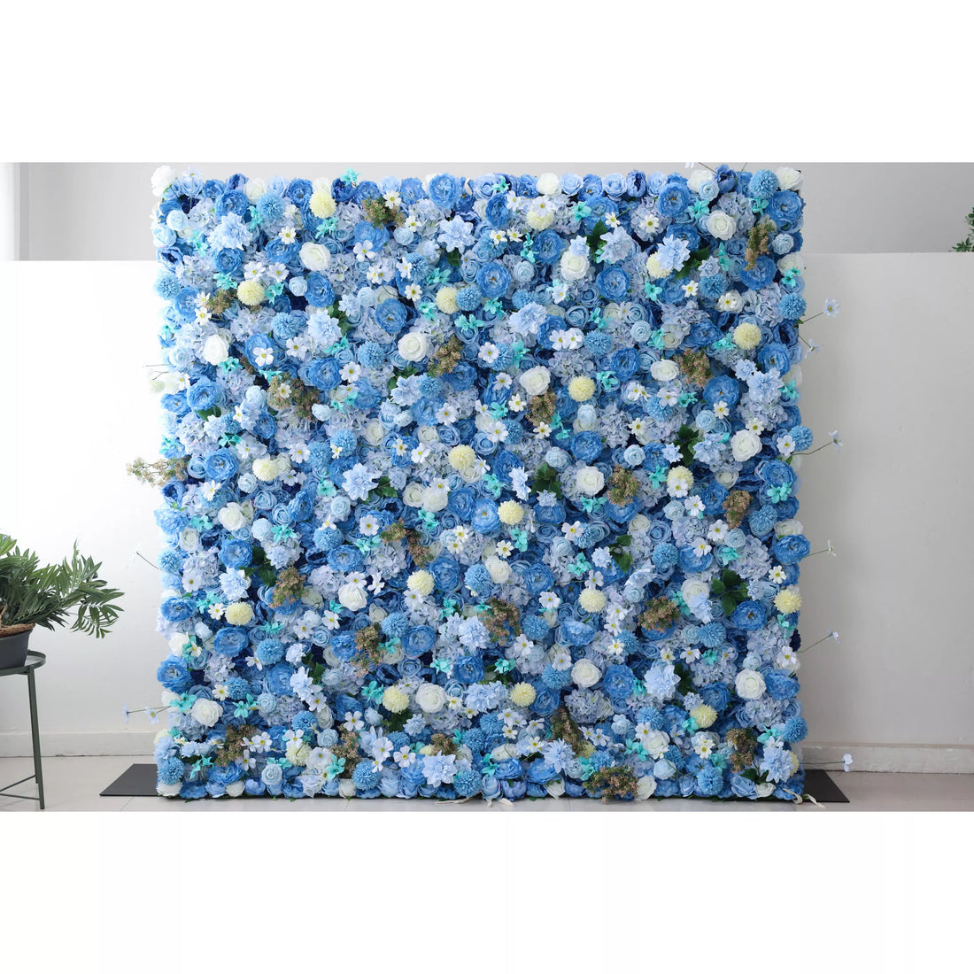 A massive artificial flower wall bursts with a harmonious blend of blue blooms—roses, hydrangeas, and delicate white flowers. Accents of yellow pom - poms and green foliage add texture. The dense, layered arrangement creates a lush, elegant backdrop, perfect for adding a touch of sophistication to events or spaces.