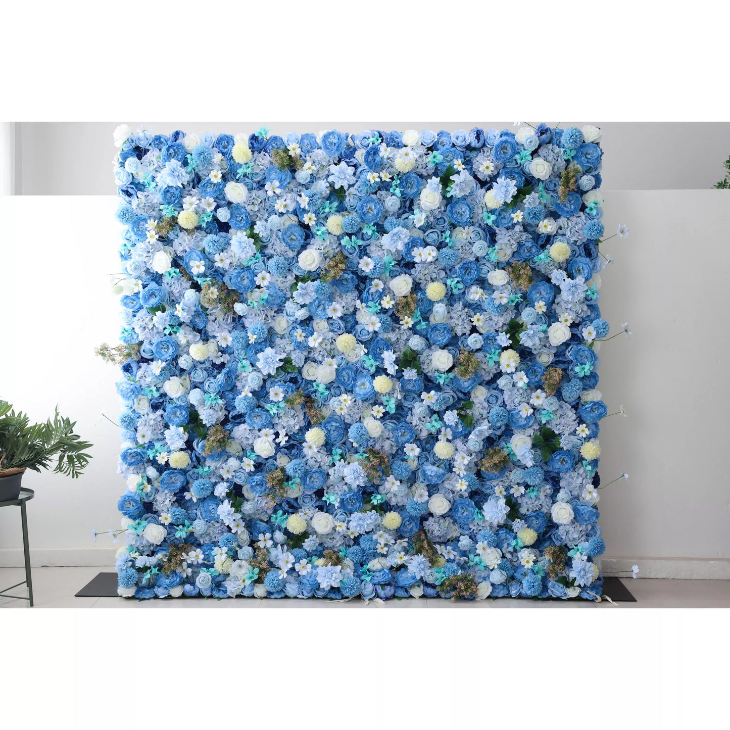 A massive artificial flower wall bursts with a harmonious blend of blue blooms—roses, hydrangeas, and delicate white flowers. Accents of yellow pom - poms and green foliage add texture. The dense, layered arrangement creates a lush, elegant backdrop, perfect for adding a touch of sophistication to events or spaces. 