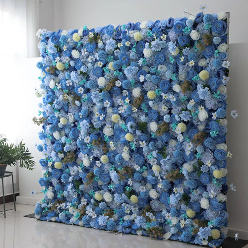 Valar Flowers' Azure Harmony: A large artificial flower wall features a lush arrangement of blue blooms, including roses, hydrangeas, and small white flowers. Accents of yellow pom - pom flowers and green foliage add texture. The harmonious blend of colors creates a vibrant, elegant backdrop, perfect for events or decorative spaces, exuding a sense of freshness and beauty. 
