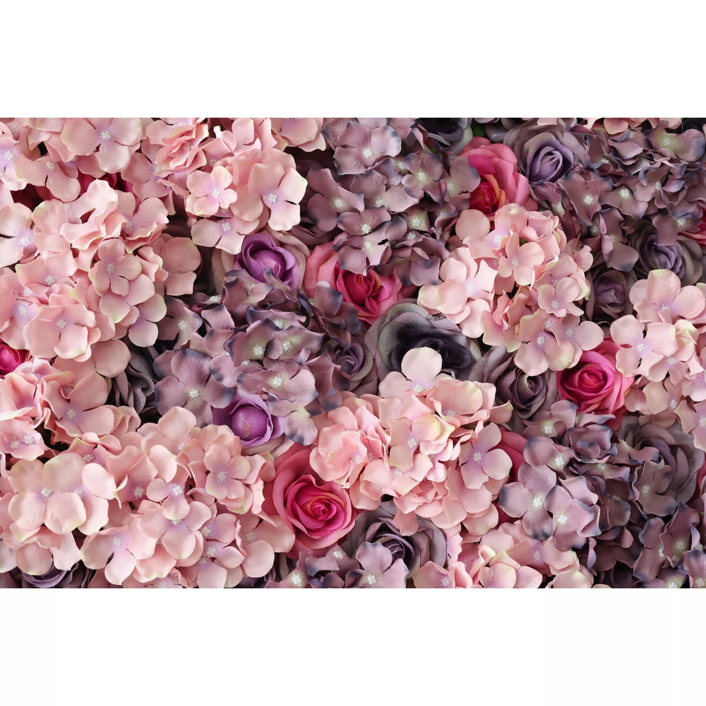 This close - up features a lush artificial flower wall. It blends soft pink hydrangeas, purple blossoms, and deep - hued roses. The dense, varied arrangement creates a romantic, elegant texture. Ideal for event backdrops, it adds a touch of refined beauty, with the harmonious mix of colors and blooms evoking a sense of timeless charm. 