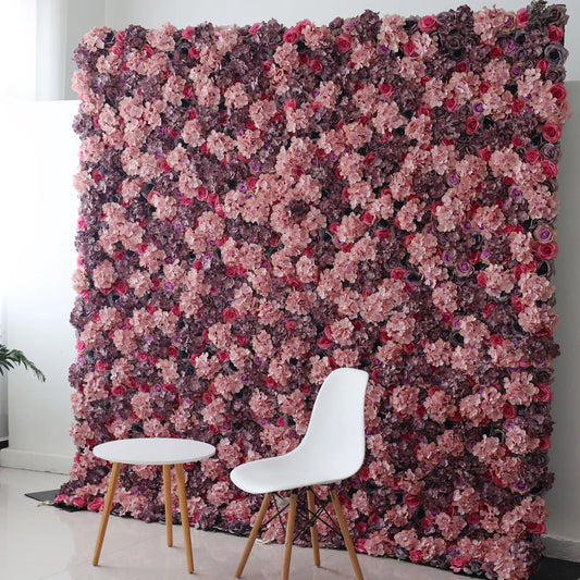 Valar Flowers Roll Up Backdrop: This picture shows a large artificial flower wall in rich hues of purple, pink, and red, with various blooms densely arranged. In front, a minimalist white chair and a small round table with wooden legs create a contrast. The setup blends natural - inspired decor with modern simplicity, ideal for photo backdrops or stylish event spaces, offering an elegant and romantic atmosphere. 