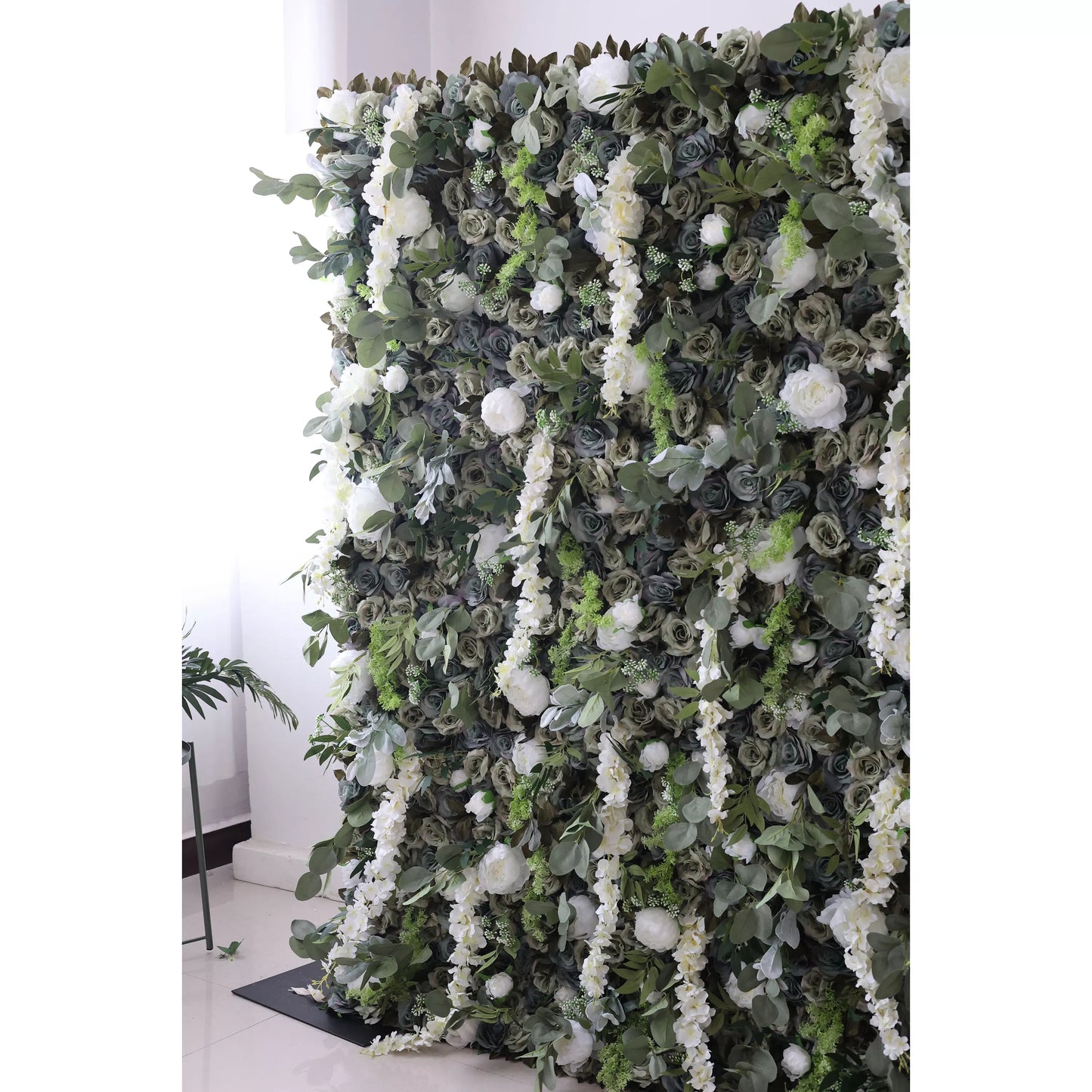 This large artificial flower wall features a lush mix of dark green roses, white blooms, trailing white flowers, and green foliage. The dense, layered arrangement creates a natural - looking, elegant backdrop, perfect for adding a touch of romance and sophistication to events or decor. 