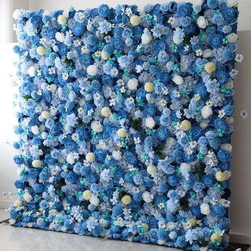 Valar Flowers' Cerulean Dreamscape: A large artificial flower wall bursts with a stunning mix of blue blooms, including roses, hydrangeas, and delicate white flowers. Accents of yellow pom - pom - like flowers and green foliage add texture. The harmonious blend of colors creates a lush, vibrant, and elegant backdrop, perfect for events or decorative spaces. 