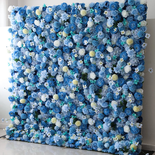 Valar Flowers' Cerulean Dreamscape: A large artificial flower wall bursts with a stunning mix of blue blooms, including roses, hydrangeas, and delicate white flowers. Accents of yellow pom - pom - like flowers and green foliage add texture. The harmonious blend of colors creates a lush, vibrant, and elegant backdrop, perfect for events or decorative spaces. 