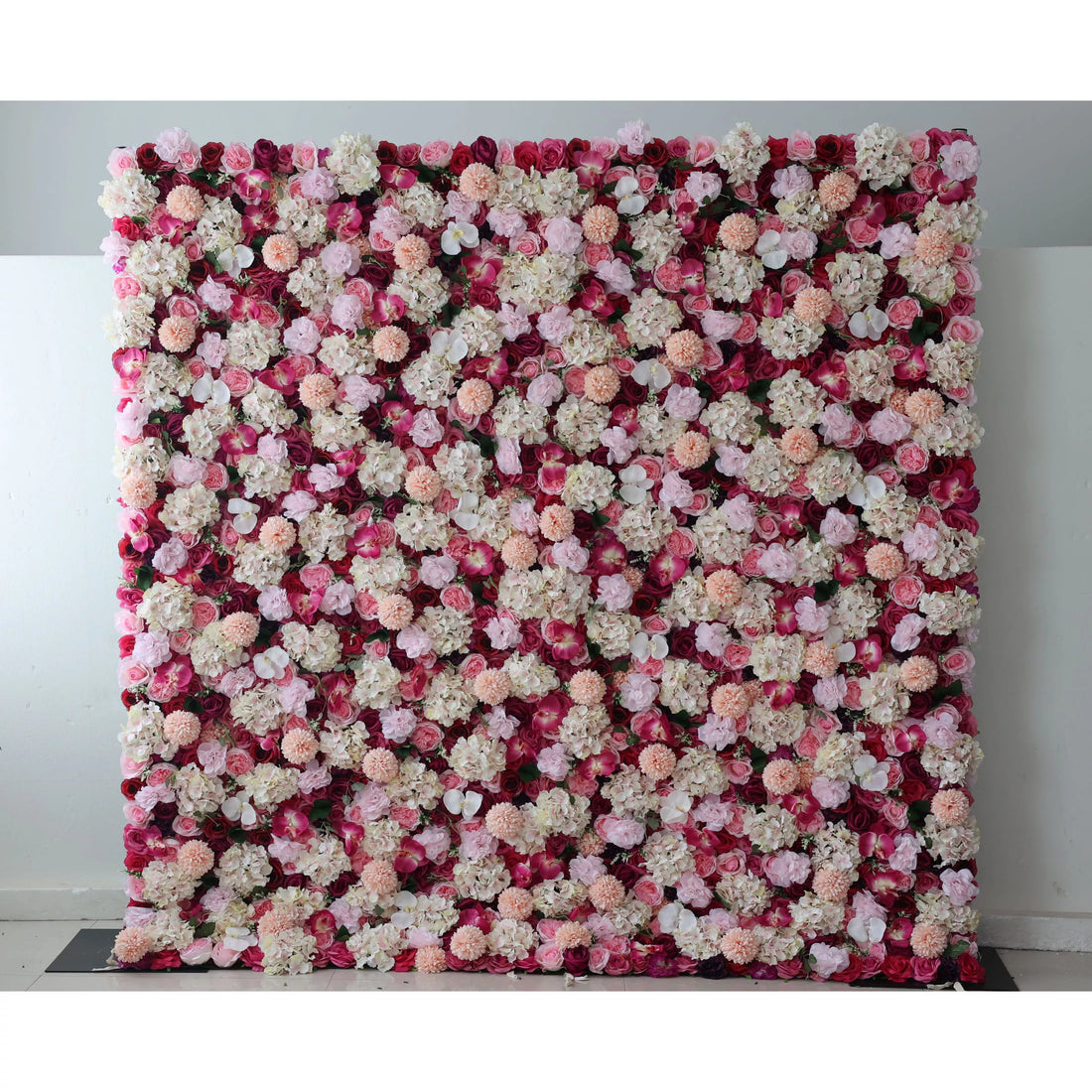 Valar Flowers: This large artificial flower wall features a rich mix of blooms. Red blossoms form the base, adorned with white hydrangeas, pink roses, peach - colored carnations, and small white flowers. The dense, colorful arrangement creates a vibrant, romantic backdrop, ideal for weddings or events, adding an elegant and decorative touch.