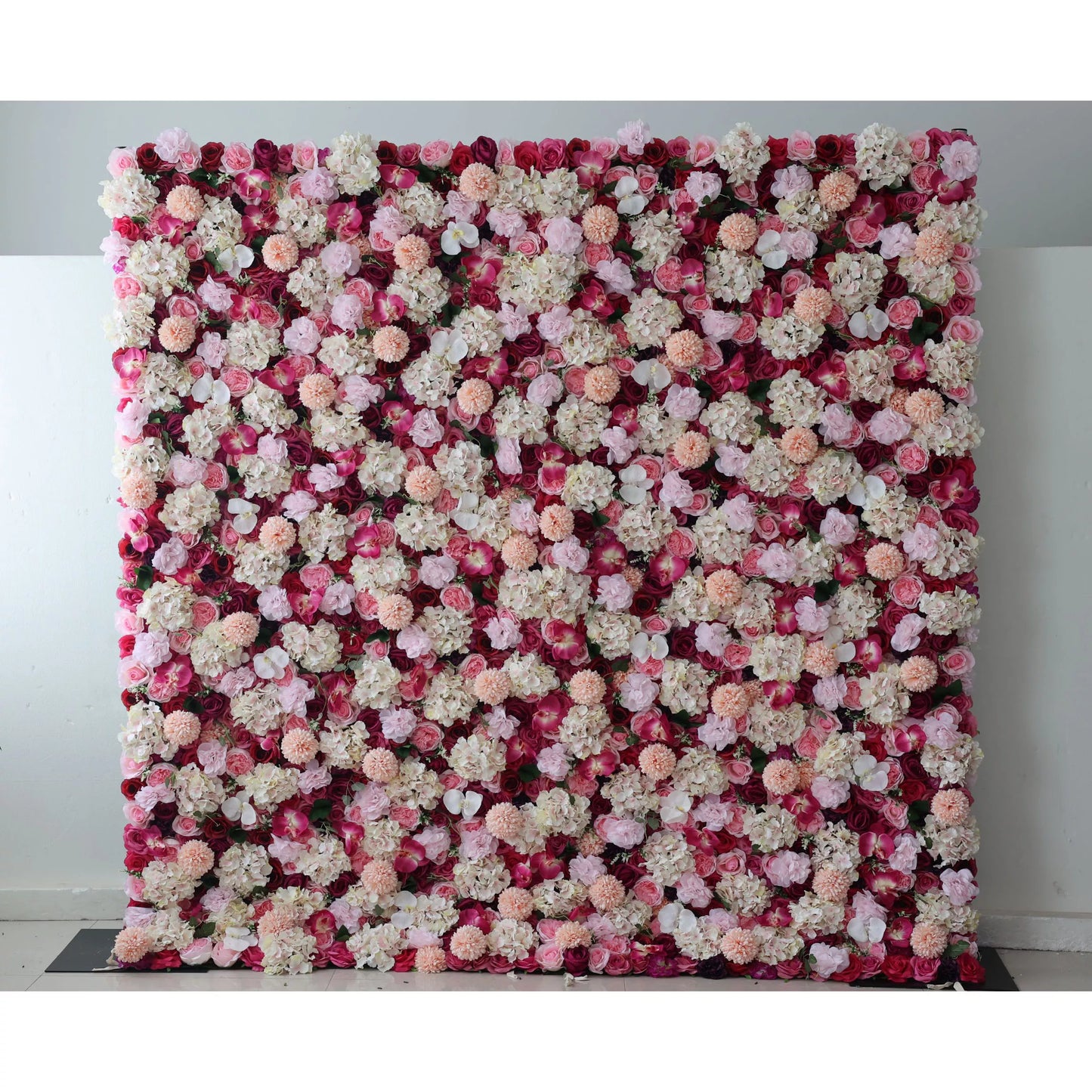 Valar Flowers: This large artificial flower wall features a rich mix of blooms. Red blossoms form the base, adorned with white hydrangeas, pink roses, peach - colored carnations, and small white flowers. The dense, colorful arrangement creates a vibrant, romantic backdrop, ideal for weddings or events, adding an elegant and decorative touch. 
