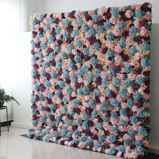 Valar Flowers Roll Up Backdrop: This is a large artificial flower wall. It showcases a vibrant mix of colors—soft pinks, blues, purples, and creams. Densely packed with varied blooms, it creates a lush, textured tapestry. Perfect for event backdrops, adding a colorful, elegant touch to weddings or parties, enhancing the decorative appeal of any space. 