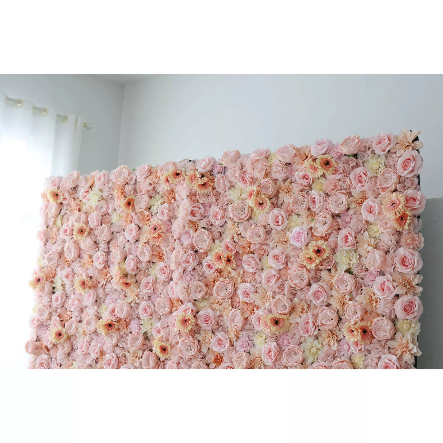This close - up showcases a large artificial flower wall, a beautiful blend of soft pink, peach, and cream tones. It’s densely packed with an array of blooms, including roses and daisy - like flowers, creating a lush, romantic display. The varied textures and pastel colors make it perfect for event backdrops, adding an elegant and charming touch to any space, ideal for weddings or parties to create a dreamy atmosphere. 