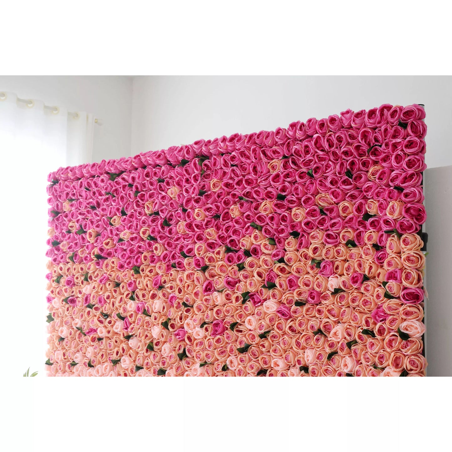 This picture showcases a large artificial flower wall, a beautiful gradient of pink tones. It’s densely packed with rose - like blooms, transitioning from deep pink at the top to soft pink at the bottom. The uniform, lush arrangement creates a romantic, eye - catching display, perfect for event backdrops. The vibrant colors and dense floral pattern add a touch of elegance and charm to any space, making it an ideal decorative element for weddings or parties. 