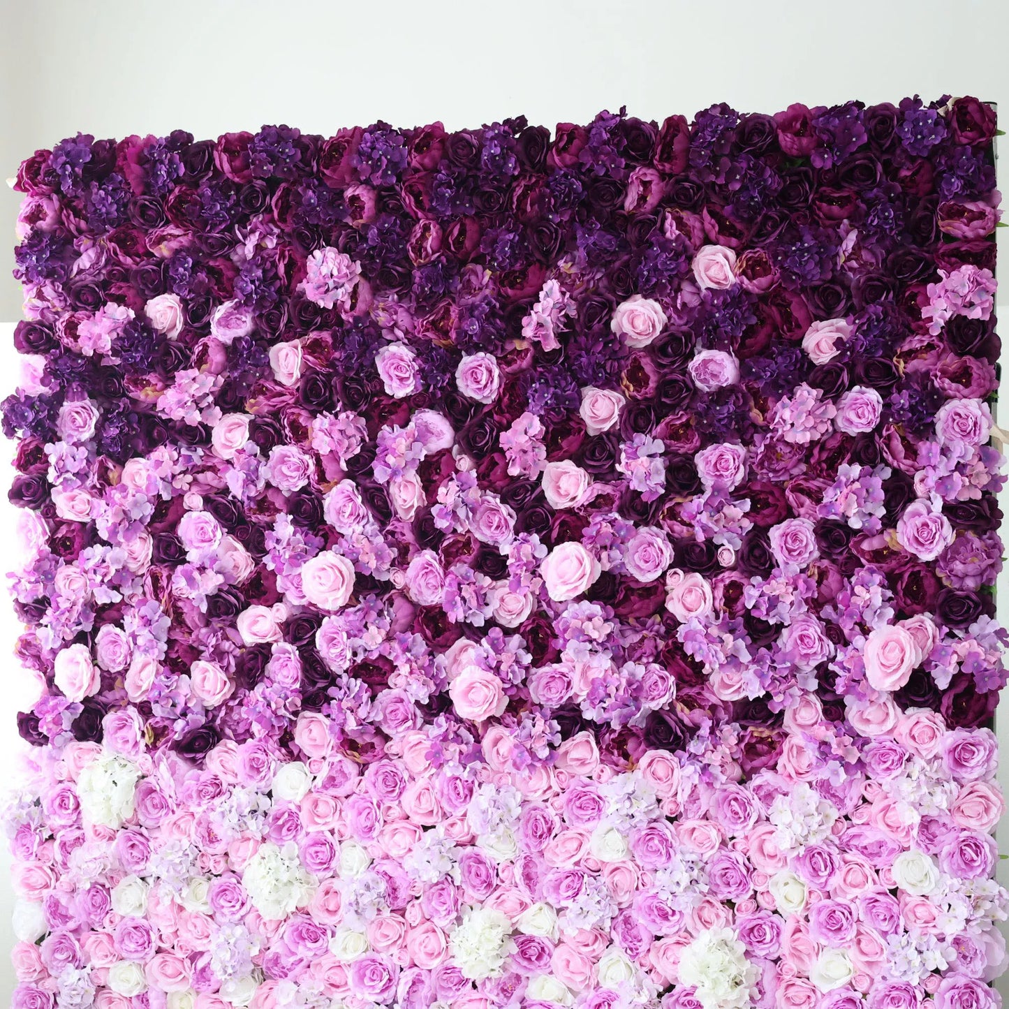 This flower wall features a gradient of purples, from deep to soft, with artificial roses and delicate blooms. The rich, dreamy hues echo Kuromi's aesthetic—mysterious yet sweet. Dense, overlapping flowers create a lush, enchanting texture, perfect for adding a touch of whimsical charm to events or decor. 
