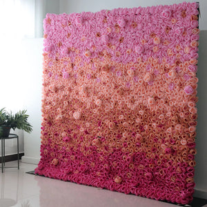 This picture features a large artificial flower wall, a gradient of pink hues. It's densely packed with rose - like blooms, transitioning from soft pink at the top to deeper pink at the bottom. The uniform, lush arrangement creates a romantic, eye - catching display, perfect for event backdrops, adding a sweet and decorative touch to spaces. A small plant on the side complements the setup. 
