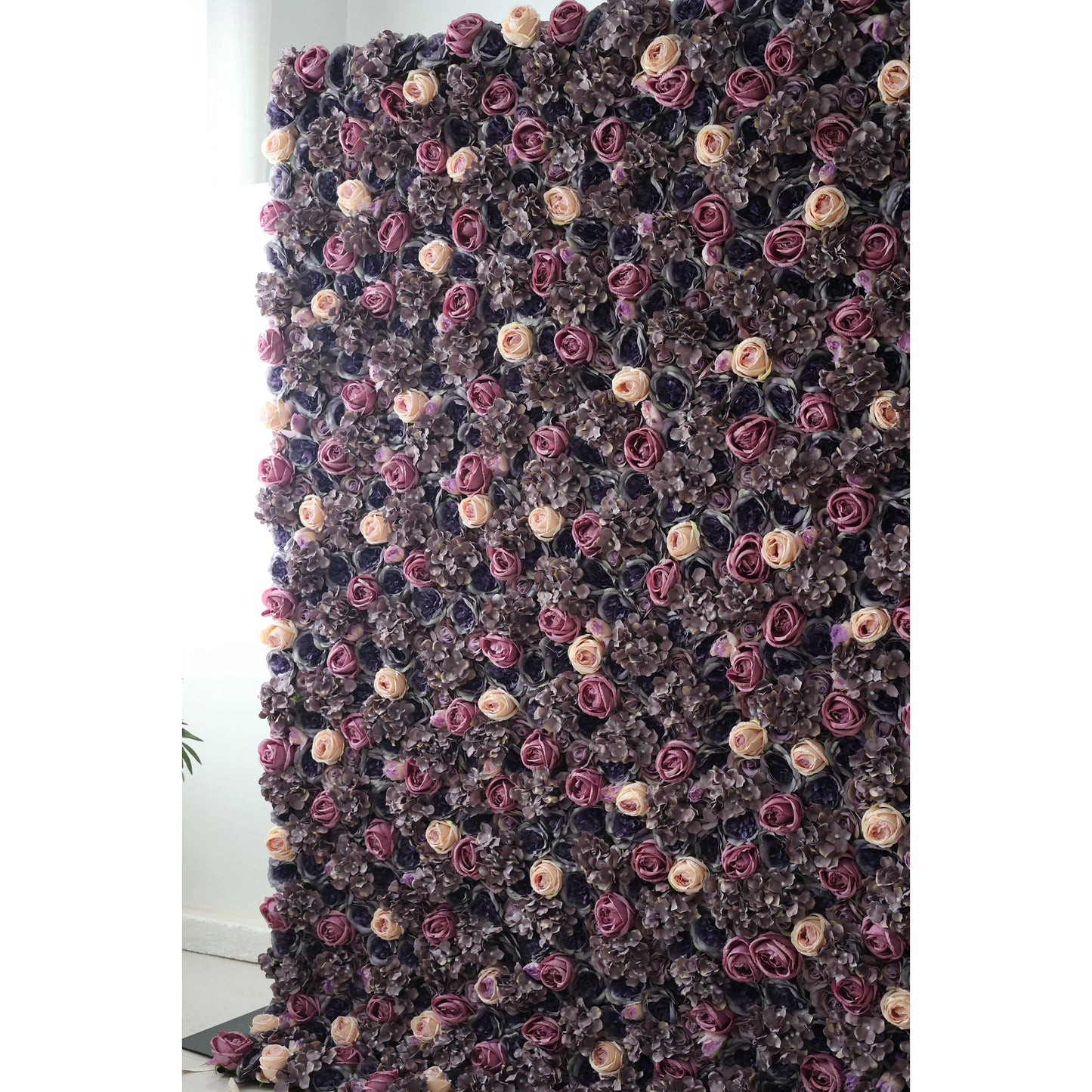 This flower wall is a dense arrangement of artificial flowers, mainly featuring roses and hydrangeas. The color scheme includes deep purples, rich mauves, and soft peachy - pink hues, creating a luxurious and elegant atmosphere. Ideal for upscale events such as weddings or formal parties, it serves as a stunning backdrop, adding a touch of sophistication and romance to the venue. 