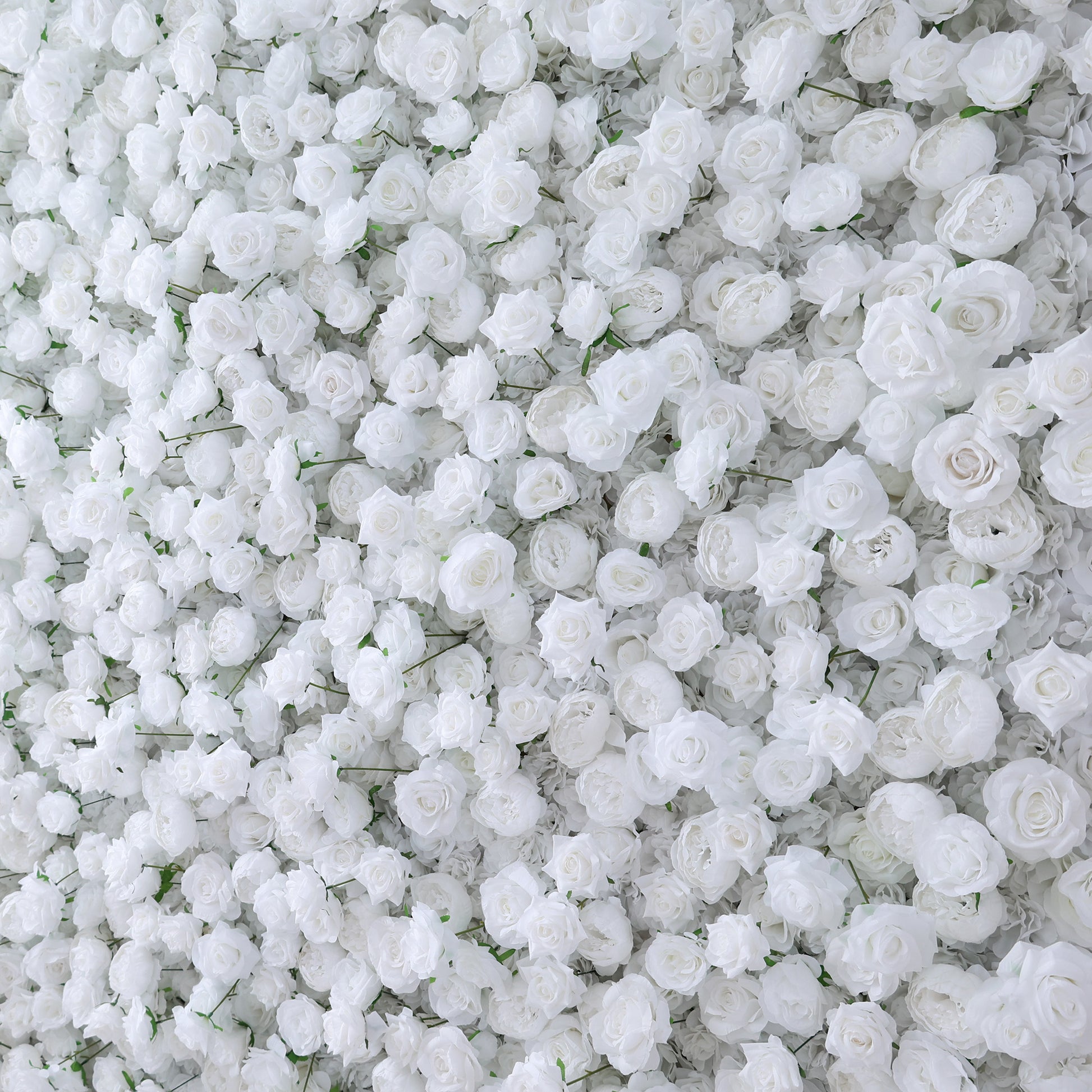 This image showcases a dense arrangement of white artificial roses, creating a lush and voluminous floral display. The flowers are tightly packed, with their soft, creamy petals and subtle green stems contributing to a sense of purity and elegance. The uniform white hue gives a serene and sophisticated look, making it an ideal decorative element for events or as a striking backdrop, evoking feelings of natural beauty and refinement.