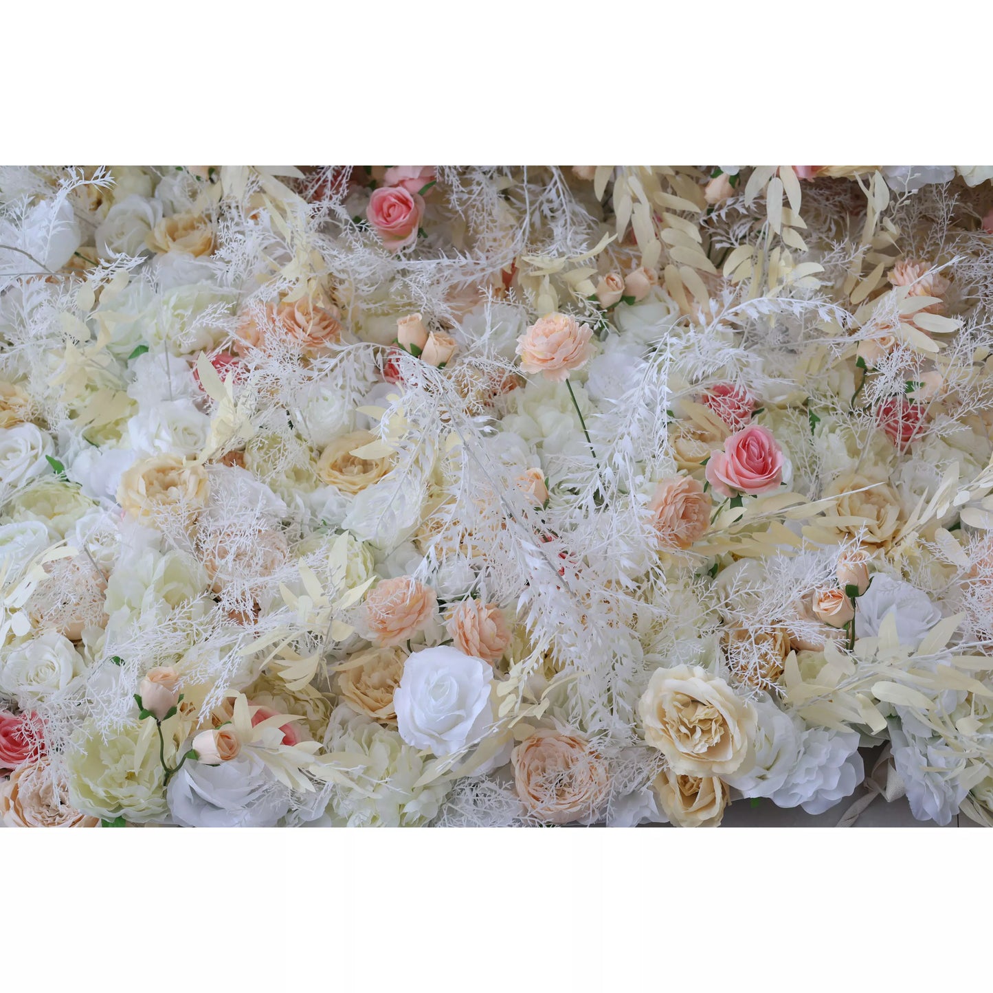 This flower wall is a harmonious blend of cream, white, and soft pink artificial blooms. It combines roses, peonies, and delicate trailing vines, creating a lush, romantic texture. Subtle color gradients and feathery foliage add depth, making it perfect for weddings or elegant events, exuding an ethereal, dreamy charm. 